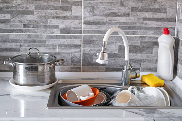 istock dirty dishes in the kitchen sink 2227819898