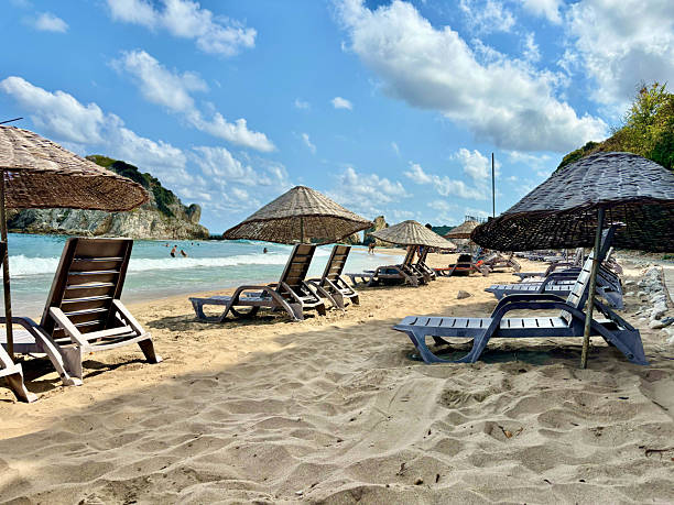 istock Empty Sunbeds and Straw Umbrellas on a Sandy Beach Resort 2227820644