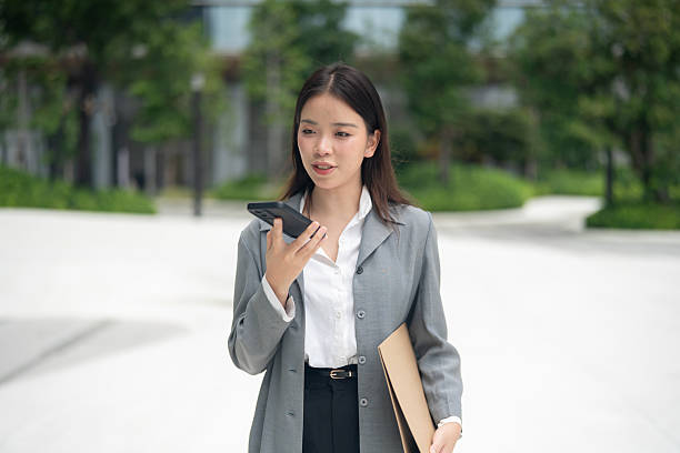 istock Businesswoman Speaking on Phone in Sunlight 2227824059