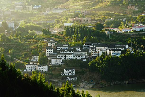 In the afternoon, the sun shines on the beautiful village nestled on the green hillside