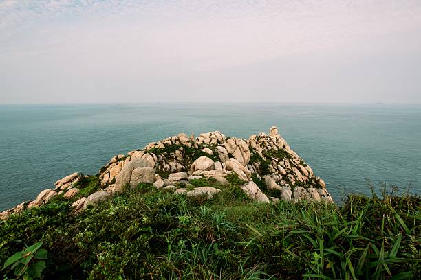 Lawn and stone hill by the sea