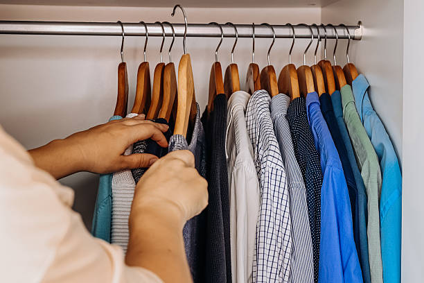 istock Woman sorting shirts in stylish minimalist wardrobe. 2227827171