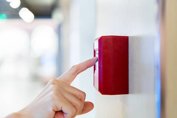 istock Woman finger pushing fire alarm 2227829289