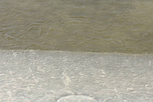 Frozen lake surface with air bubbles in ice