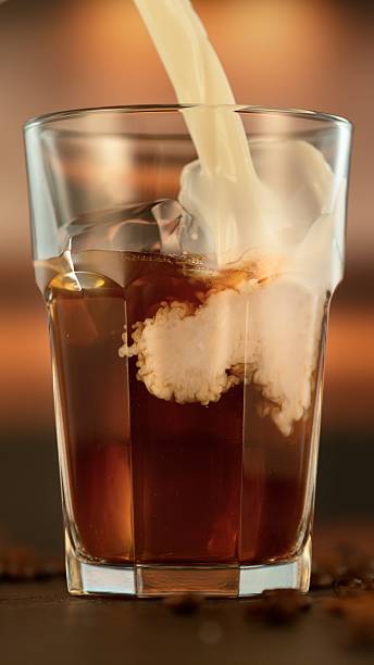 istock Refreshing coffee with pouring milk into glass 2227831704