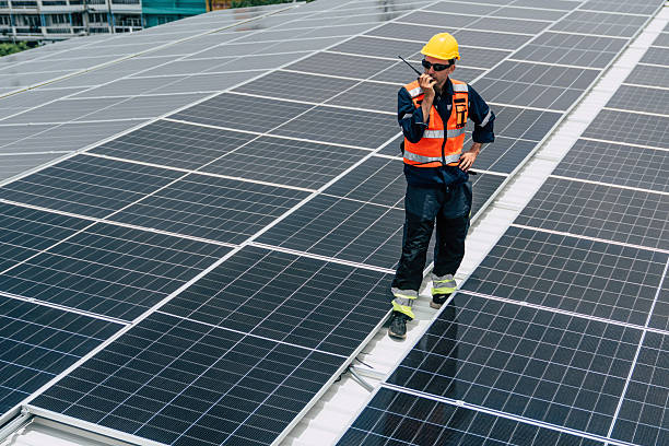 istock Solar panel technician working on rooftop installation in urban area during daylight 2227831897