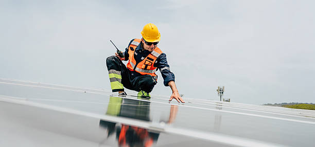istock Worker inspects solar panels on a rooftop during daylight in a renewable energy project 2227832189
