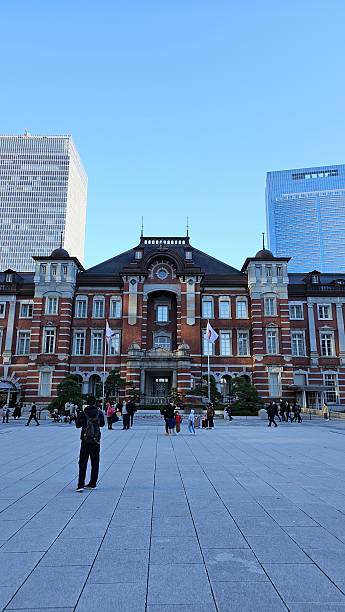 Tokyo, Japan – December 13, 2023 – Photo of Tokyo Station Central Entrance with Classic Red Brick Western Architecture from the Showa Era, Urban Nightlife, Daily Cityscape, and Transportation Hub