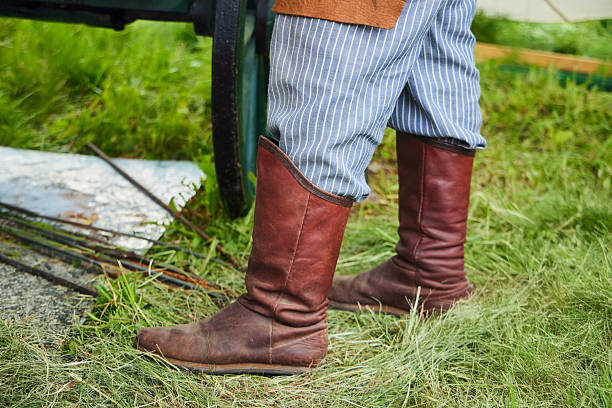 istock Feet in antique blacksmith's leather boots. Historical reconstruction 2227832676