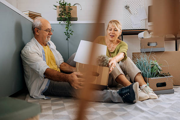 istock Senior couple unpacking boxes at new home 2227832871