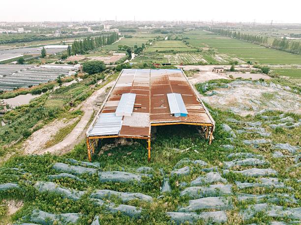 An abandoned factory building in the fields by the river