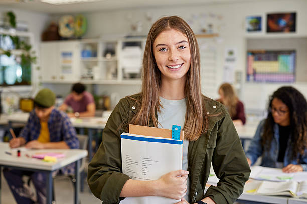 istock Smiling student girl in classroom at high school 2227835250
