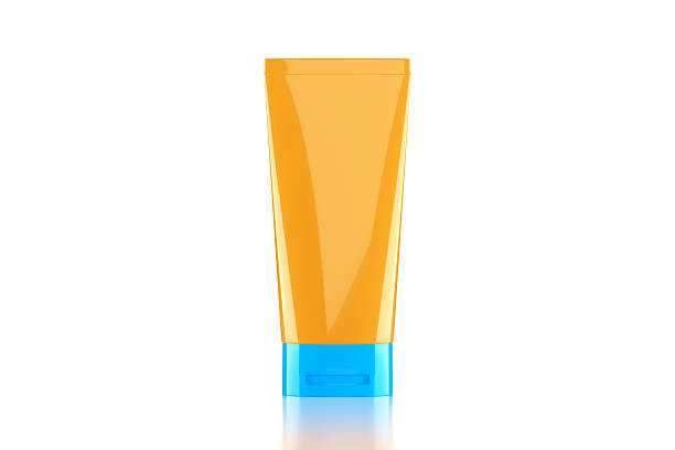 Blank yellow cosmetic tube sitting on white background. Horizontal composition with clipping path and copy space.