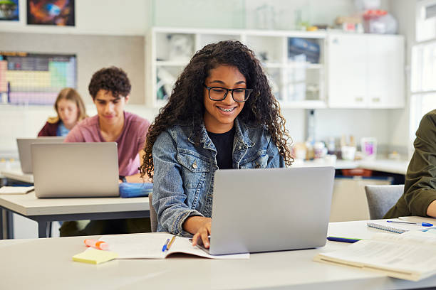 istock Happy smiling african american girl using laptop in class 2227835789