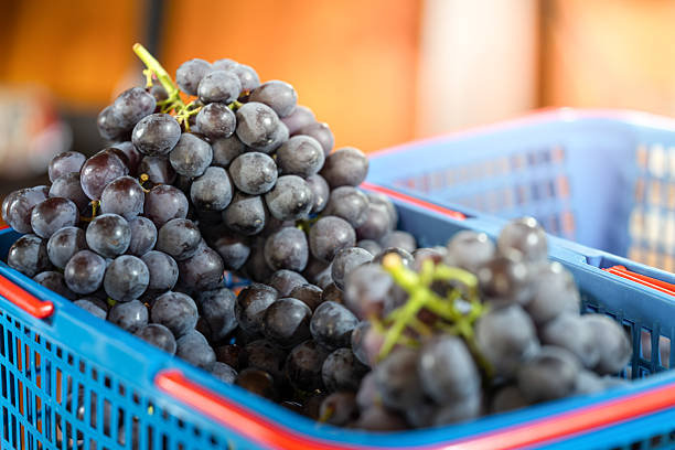 Fresh Grapes in a Blue Basket at the Market