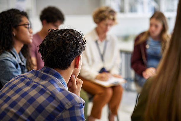 istock Counseling group session with teens at school 2227837167