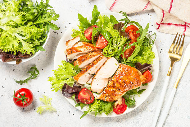istock Grilled chicken with fresh salad at table. 2227837523