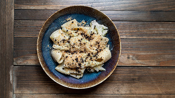 istock Paccheri with breadcrumbs and black truffle on a rustic ceramic plate 2227842148