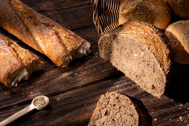 Artisan bread assortment on rustic wooden table, fresh bakery food concept