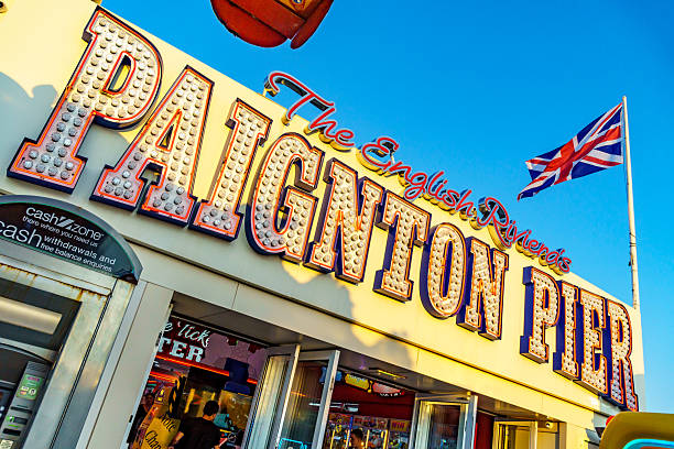 Paignton, UK. 30 July 2025. Sign for Paignton Pier with Union Jack flag