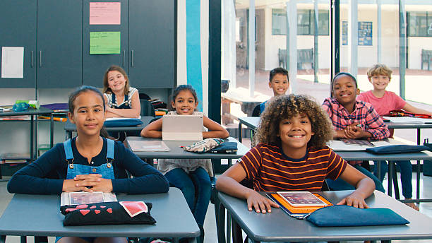 istock Portrait Of Smiling High School Class Using Digital Tablets In Class 2227845510