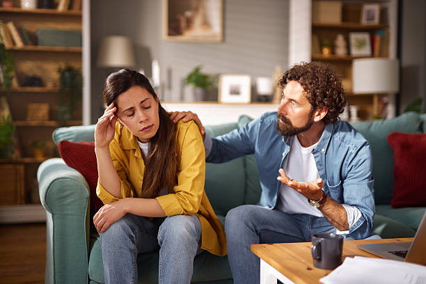 istock Worried couple discussing financial problems at home 2227846155