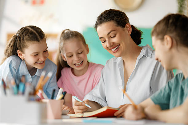 istock Happy kids and teacher at school 2227847048