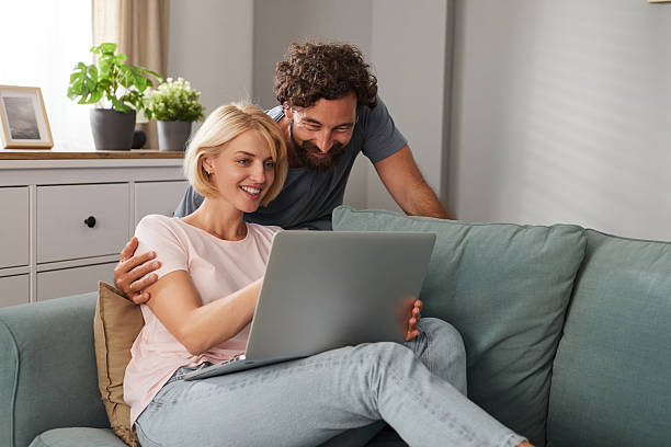 istock Couple enjoying an intimate moment together while browsing on a laptop in their 2227847571