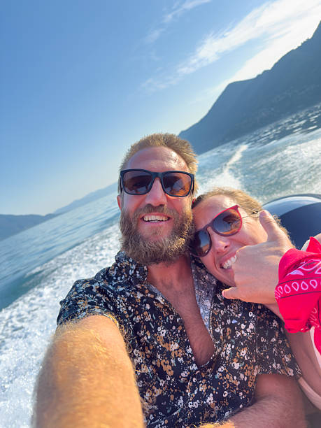 istock Happy Couple Taking Selfie on Speedboat Ride 2227850282