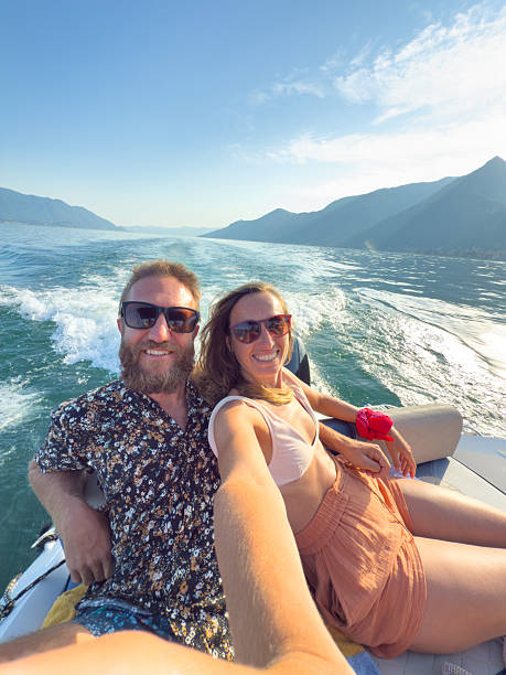 istock Happy Couple Taking Selfie on Speedboat Ride 2227850798