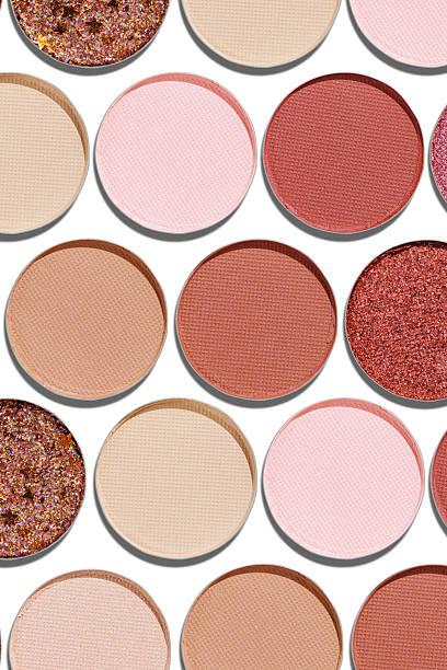 istock Colorful Swatches eyeshadow refills as minimal geometric pattern. Matte and glitter pans red brown pink shade with sun shadows, detail texture, cosmetic, beauty product, makeup, warm color scheme 2227851447