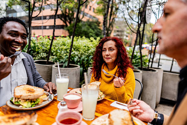 istock Coworkers talking and having breakfast in the coffee shop 2227851981
