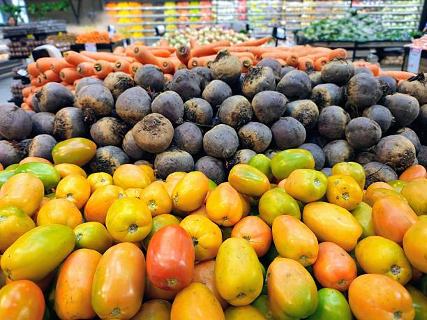 Vegetables stacked in a supermarket shelf.