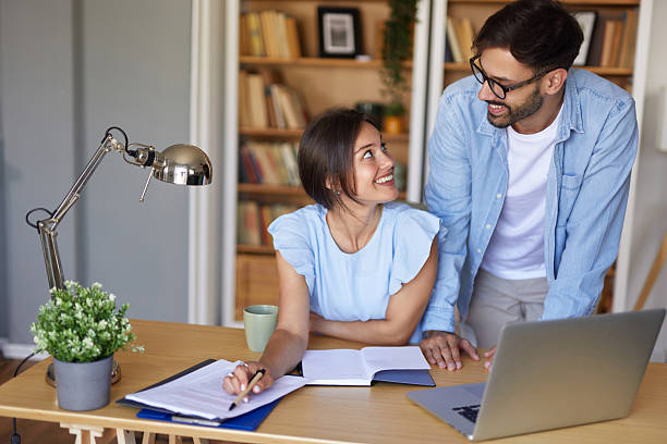 istock Young couple working from home smiling and sharing ideas 2227852418