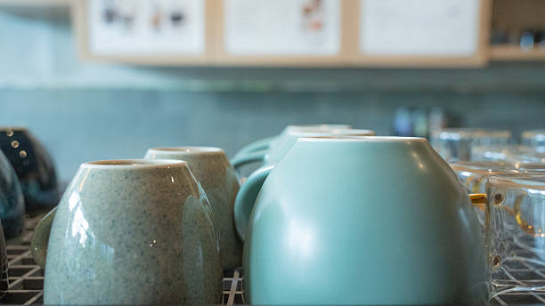 Textured pottery: coffee shop mugs on display.