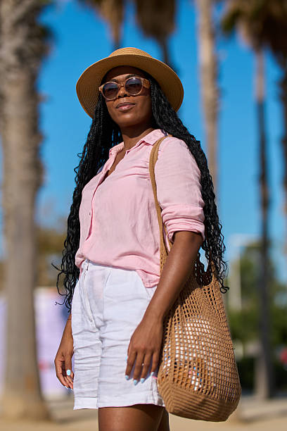 istock Stylish tourist exploring a tropical destination under palm trees 2227861300