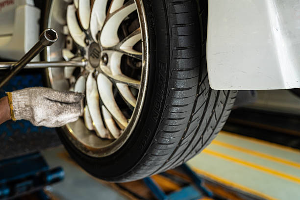 istock Mechanical man working on car changing tire in vehicle garage 2227862173