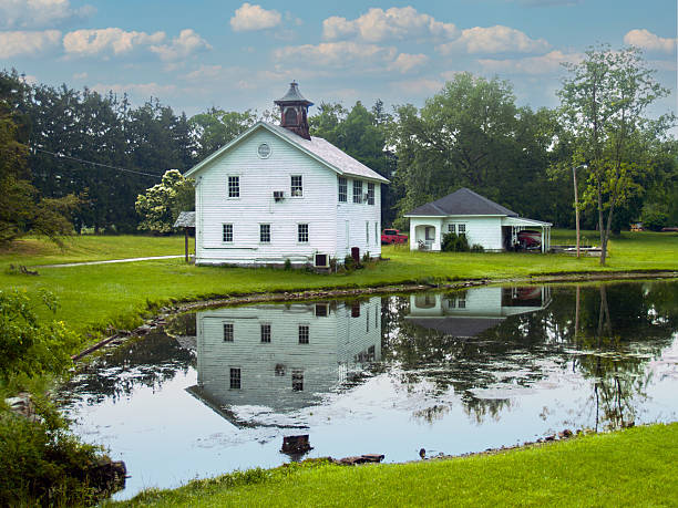A rural scene in Warren County, New Jersey with old buildings reflecting in the pond.