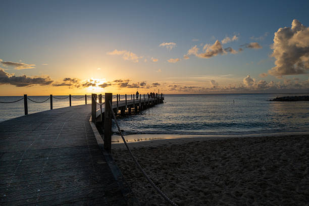 istock Curved Pier Leading to Sunset Gathering in Barbados 2227865458