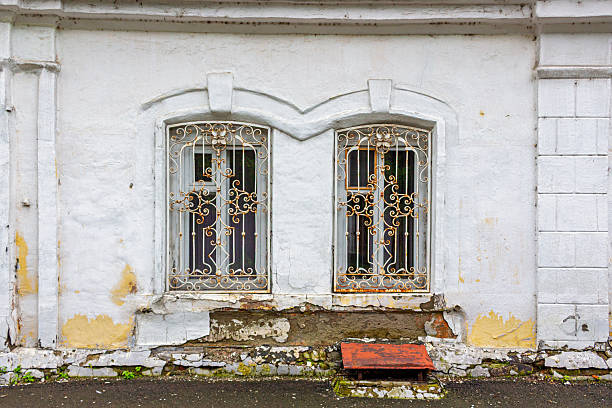 istock White rusty lattice on windows at a stone house 2227866150