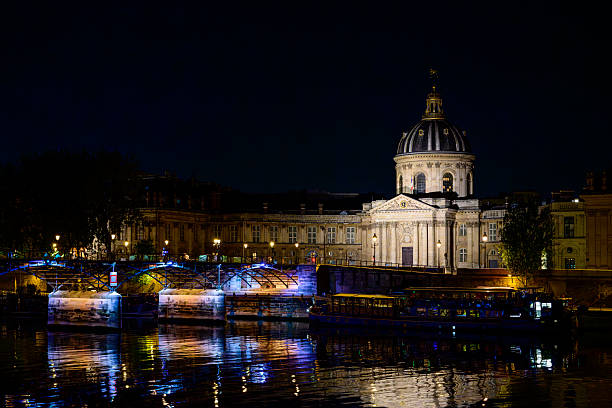 Paris : Institut de France, by night, on Seine quayside, with Pont des Arts