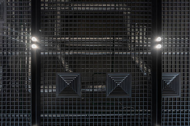 A contemporary interior ceiling design featuring grid-patterned panels and integrated lighting, creating a sleek and stylish atmosphere suitable for modern spaces including offices, commercial buildings, and innovative architectural setups.