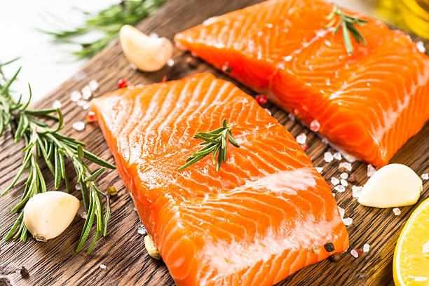 istock Salmon fish with ingredients at white table. 2227868682
