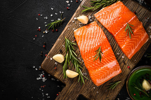 istock Salmon fish with ingredients at black table. 2227868743
