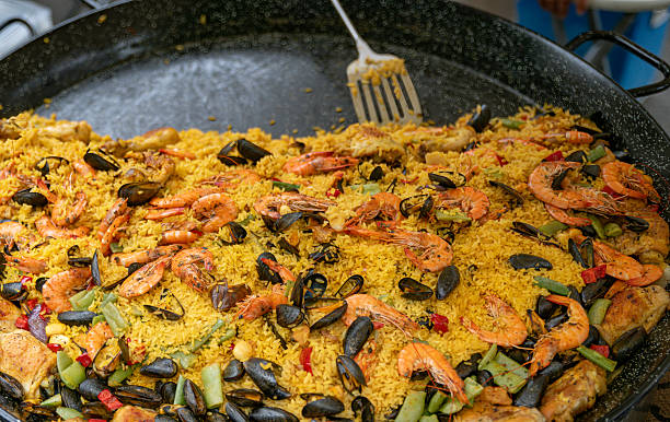 istock Authentic Spanish Paella with Seafood, Chicken, and Vegetables in a Large Pan 2227868964
