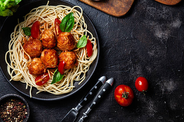 istock Spaghetti and Meatballs Dish with Fresh Tomatoes and Basil 2227868969