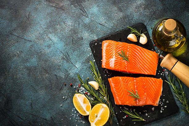 istock Salmon fish with ingredients at black table. 2227869113