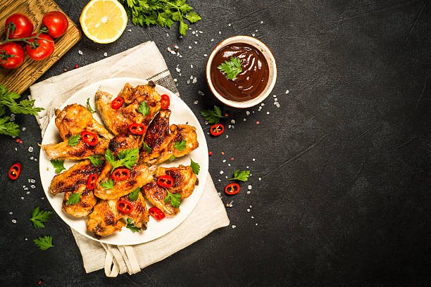 istock Grilled chicken wings at black. 2227871659