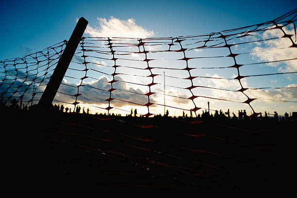 istock Several unidentified people, silhouetted against clouds and a blue sky in the background. Dramatic sunset. Winter season. 2227872889
