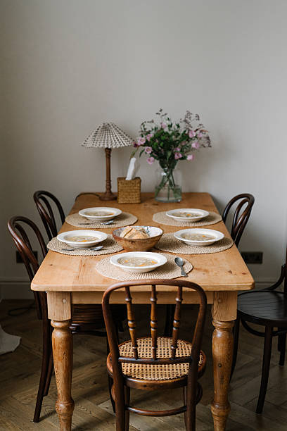 istock Five plates with Chicken noodle soup, loaf of bread, aesthetic table setting with ceramic crockery, elegant table decoration, wooden dining farmhouse table, warm and cozy 2227874863